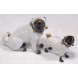 Two Meissen models of pug dogs, 7cm & 5cm highBoth dogs have repairs to the collars/bows, with