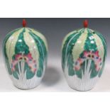 A pair of Chinese famille verte ginger jars and covers decorated with butterflies and foliage,