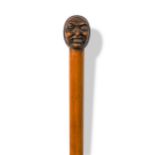 A carved wood walking cane, late 19th or early 20th century,