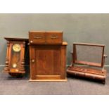 A mahogany toilet mirror, Vienna type wall clock, oak two drawer unit and a pine single door