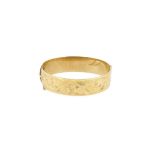 A half engraved hinged bangle,