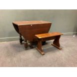 An oak drop flap gateleg dining table (74 x 107 x 57cm closed, 74 x 107 x 151.5cm open) and a
