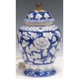 A modern hand-painted blue and white baluster lamp, with floral decoration 36cm high