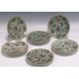 A set of six 19th century Canton enamel celadon ground plates, decorated with blossoms,