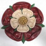 A carved and painted Tudor rose, 31cm diameter