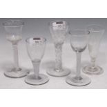 Three 18th century air twist wine glasses, an engraved ale glass and another