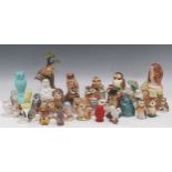 A collection of Goebel pottery character owls, Disney character owls, and further model owls to
