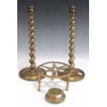 A pair of tall brass twist stem candlesticks, 19th century, a brass hubcap marked 'Sudbury', and a