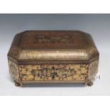 A Chinese Export lacquered and decorated box, of typical canted shape, with tray of bone sewing