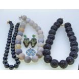 A string of volcanic beads, together with a string of agate beads, a string of freshwater pearls, an