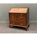 An early 18th century oak bureau with three long drawers below a false drawer front, on bracket