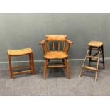 An early 20th century beech and elm smoker bow armchair stamped to seat; together with a strap