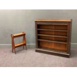 A late Victorian oak bookcase, the frieze carved 'BOOKS LIKE FRIENDS SHOULD BE FEW AND WELL