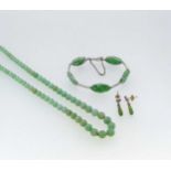 A carved jade bracelet stamped '18CT', weight 12.5g, together with a bead necklace and a pair of ear