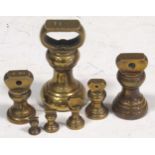 A set of bell weights from a pound to a quarter ounce
