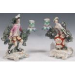 A pair of Derby porcelain figural bocage back candlesticks, 18th century, the male and female