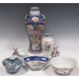 A group of eight oriental porcelain items, including an 18th century mandarin baluster vase, Dehua-