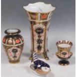 Royal Crown Derby - a flared rim vase on four feet, 17.5cm high, a small Campana shape vase, a