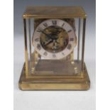 A brass skeleton clock, with Roman chapter ring, 21 x 20 x 15cm We cannot guarantee for the skeleton