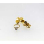 A hallmarked 18ct gold white stone ring, a brooch tested as 18ct gold and a single tigers eye