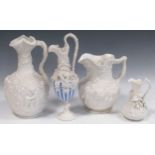 Four Copeland parian jugs, moulded and applied with fruiting vines and cherubs, the tallest 29cm