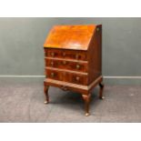 An early 18th century style walnut shaped front bureau, on cabriole legs 100 x 66 x 46cm