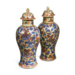 A pair of Chinese blue and white porcelain 'clobbered' vases, 18th century,