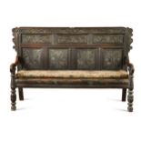 A carved oak panel back settle, 17th century and later,