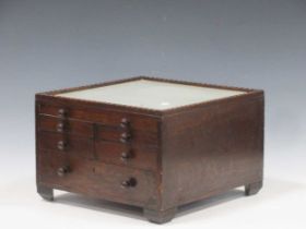 An early 20th century oak specimen collectors cabinet with glass inset top 24 x 35 x 35cm 24