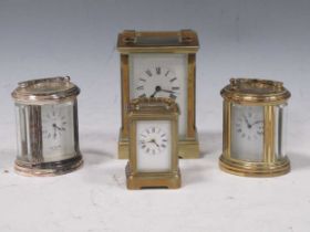 An early 20th century brass carriage clock, 10.5cm high; together with three small carriage
