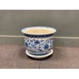 A Chinese blue and white jardiniere and circular tray, total 32cm high and 41cm diameter