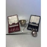 Two cased sets of silver spoons, together with a silver punch ladle, a silver teaspoon and a
