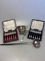 Two cased sets of silver spoons, together with a silver punch ladle, a silver teaspoon and a