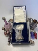 A collection of silver mounted glass perfume bottles, together with three punch ladles, a cream