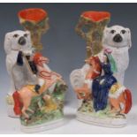 A pair of Staffordshire vases modelled with spaniels, 34cm and 33cm high, two Staffordshire figures,