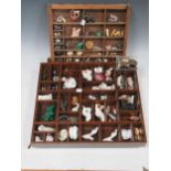 A collection of miniature china, figures and objects, animals and fossils etc in three wooden trays