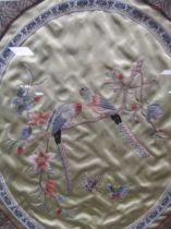 An oval Chinese textile love birds, 39 x 34cm