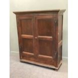 An oak panelled two door hanging cupboard, 165 x 147 x 55cm