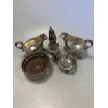 A collection of silverware including bottle coaster, cruets, sauce boats etc, 21ozt weighable