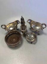 A collection of silverware including bottle coaster, cruets, sauce boats etc, 21ozt weighable