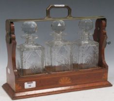 A tantalus with three cut glass decanter, the carry case with inlaid details, 31 x 40 x 15cm Not