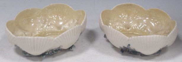 A pair of Belleek bowls, moulded with shells and seaweed, black marks, 18cm wide One with a bad