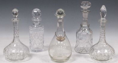 A collection of five cut glass decanters, one with a decanter label, 31cm high and similar