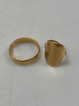 A hallmarked 22ct gold wedding band weight 6.5g, together with a misshapen sovereign ring, shank