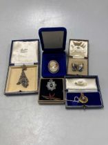 A hallmarked 9ct gold Royal Marines badge, a brooch stamped '9CT', and a hallmarked 9ct gold cameo