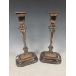 A pair of plated candlesticks, 32cm high