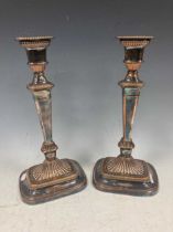 A pair of plated candlesticks, 32cm high