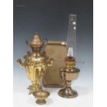 A brass and glass oil lamp, together with a brass plate and bowl, a kettle, and a larger
