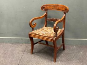 A late Regency mahogany armchair on sabre legs