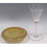 A wine glass with an engraved trumpet bowl, on an air-twist stem, 17cm high; an amber-coloured glass